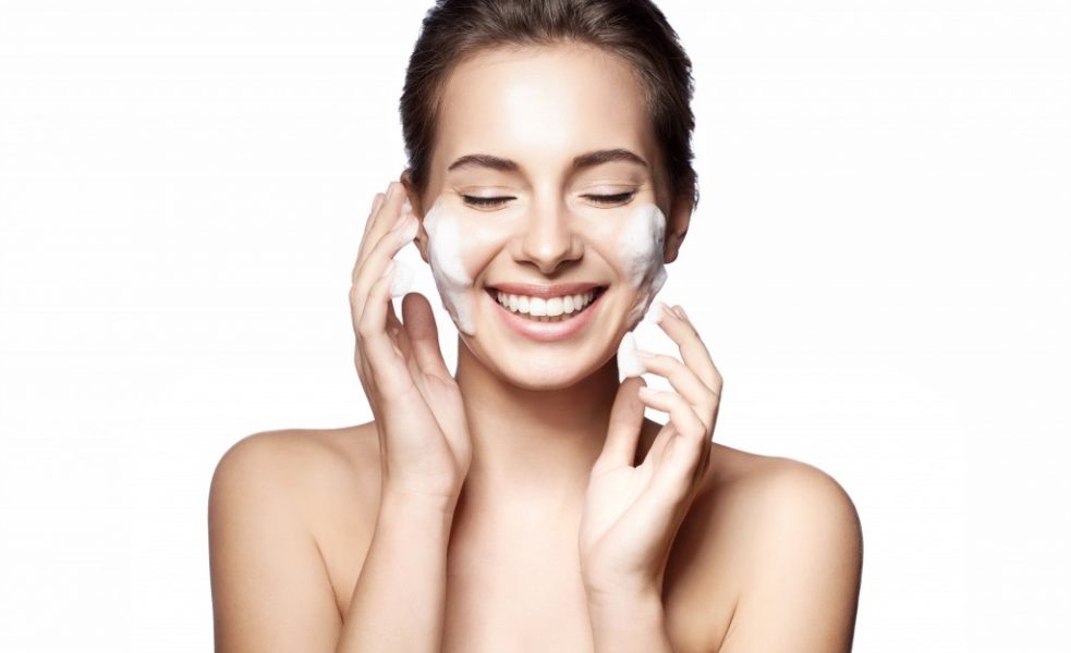 Woman applying facial cream