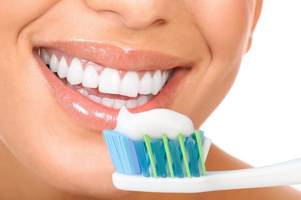 White teeth with toothbrush and toothpaste