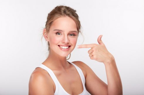 Woman pointing to her teeth