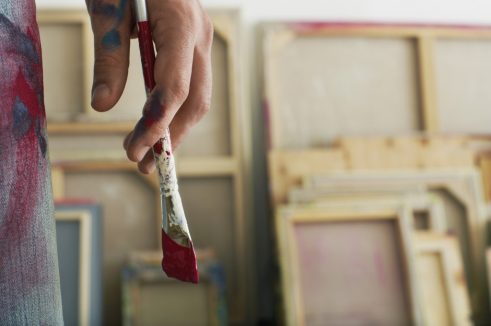Close up of an artist holding paint brush