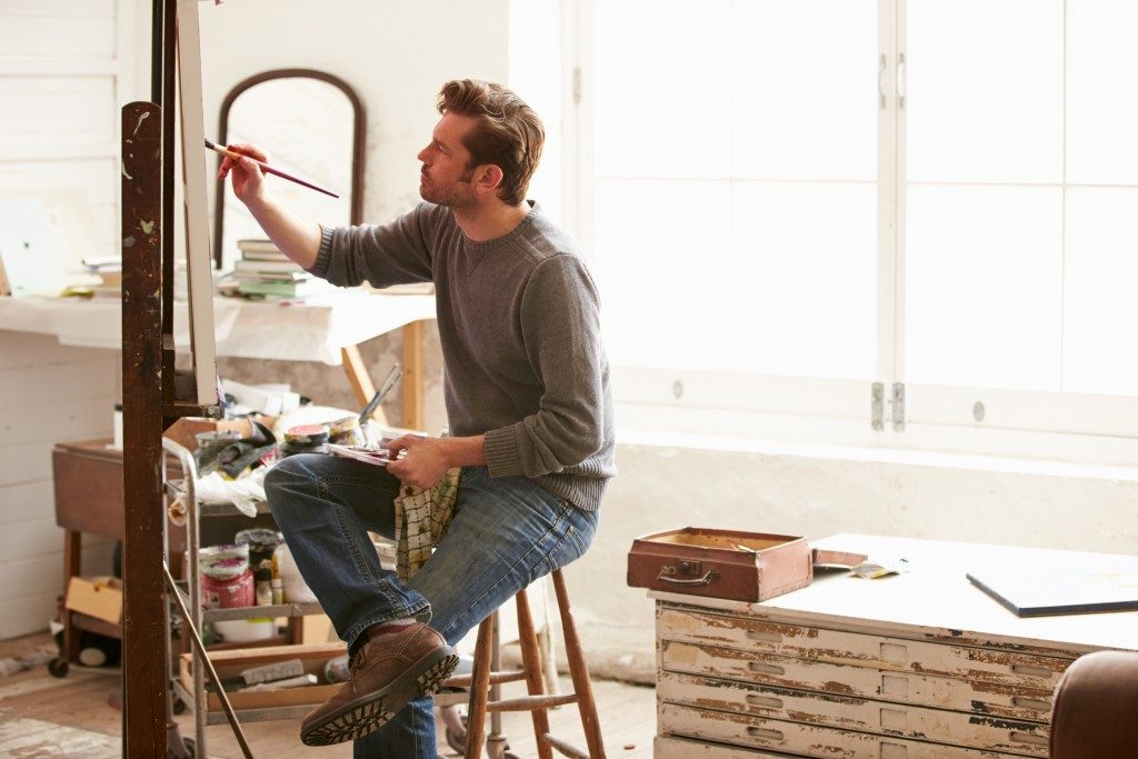 Man painting at an art studio