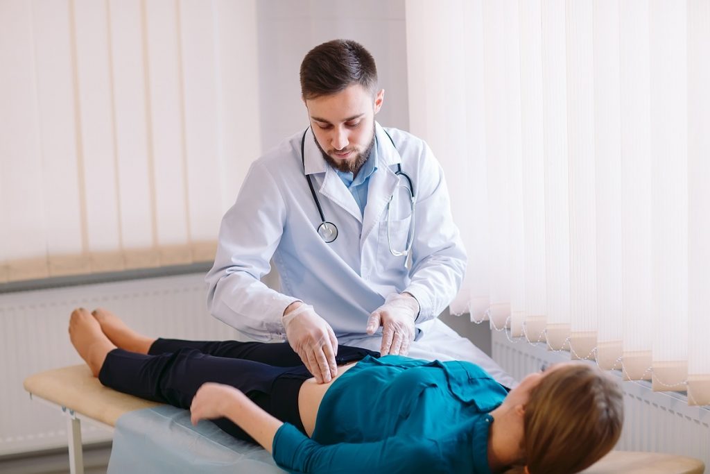 doctor checking woman's body