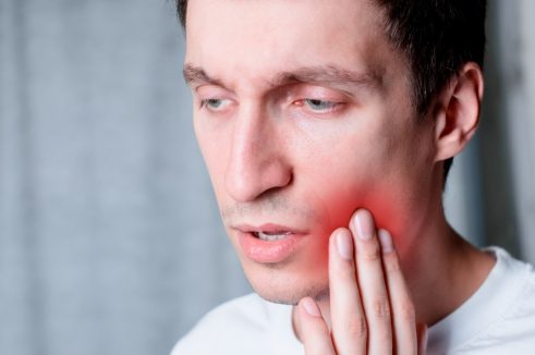 man suffering from dental pain
