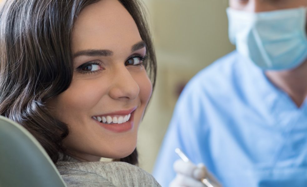 woman smiling confidently at the dentist