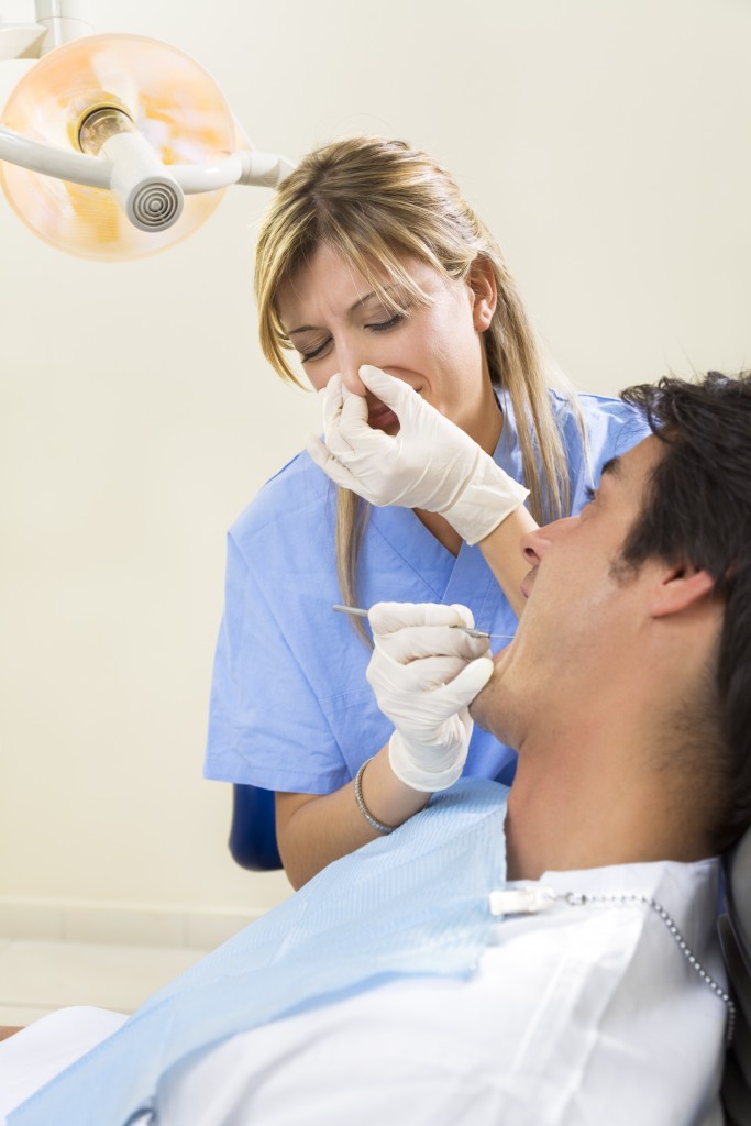 Man with bad breath in dental office